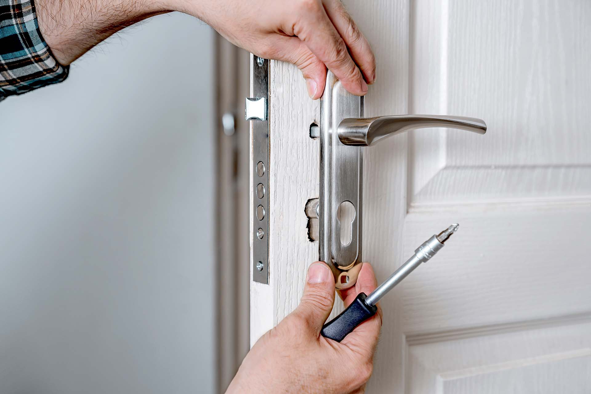 Residential locksmith replacing a high-security cylinder